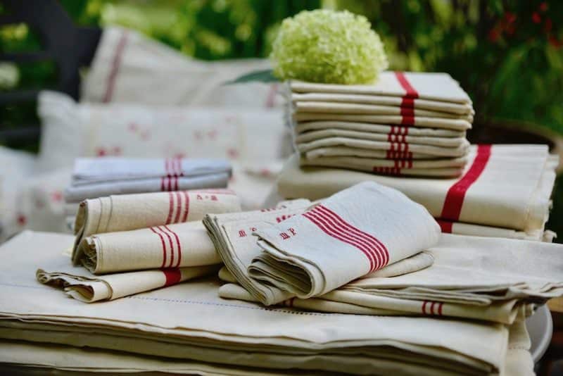 antique linens piled onto table